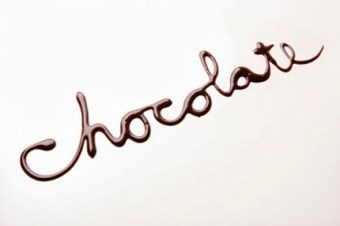 The word chocolate written in chocolate syrup on white backgroun